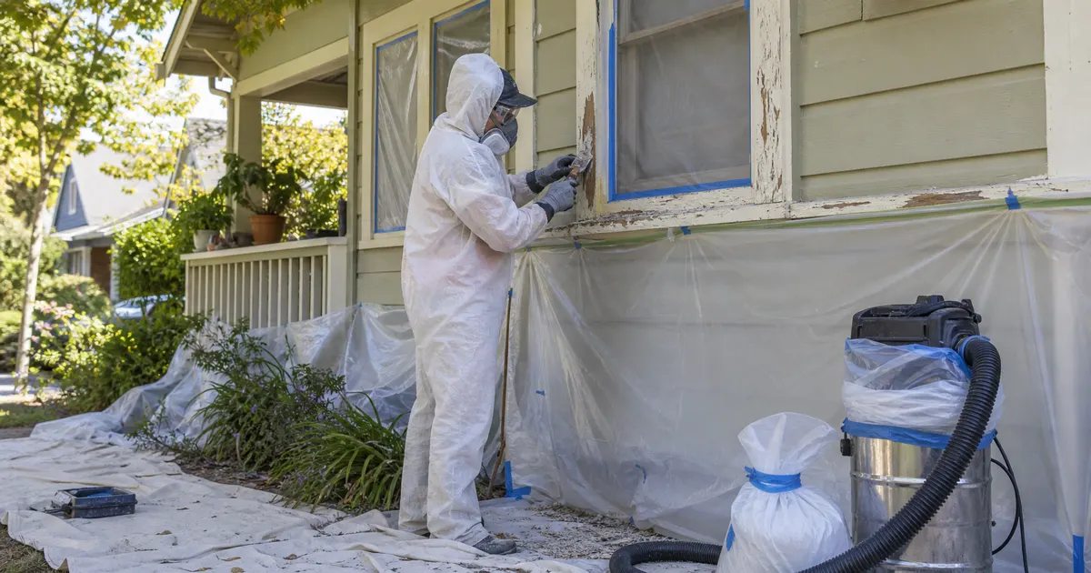 Lead-safe exterior paint preparation on an older Davis home with containment sheeting, protected windows, scraping, PPE, and HEPA cleanup equipment